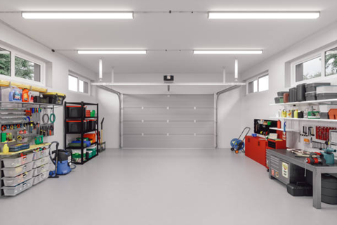 image of inside a garage, tools and workbenches along the walls with the garage door closed